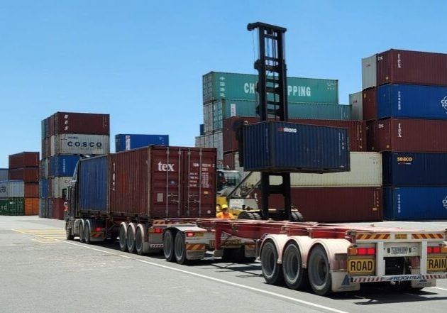 1215 NTI Adelaide - A-double combination being loaded with empties (4 x TEU per vehicle)